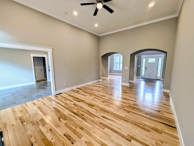 unfurnished living room with crown molding, light hardwood / wood-style floors, and ceiling fan