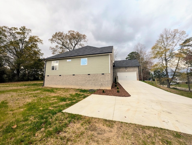 view of property exterior with a garage and a lawn