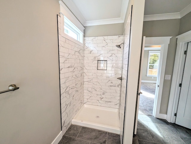 bathroom featuring tiled shower, ornamental molding, and tile patterned flooring