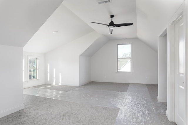 bonus room featuring light colored carpet, vaulted ceiling, and ceiling fan