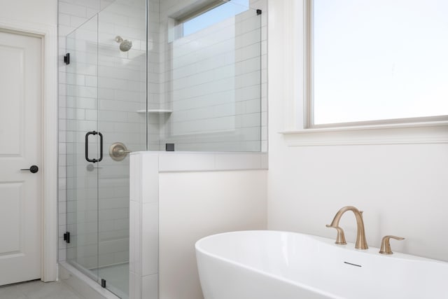 bathroom with separate shower and tub, a wealth of natural light, and sink