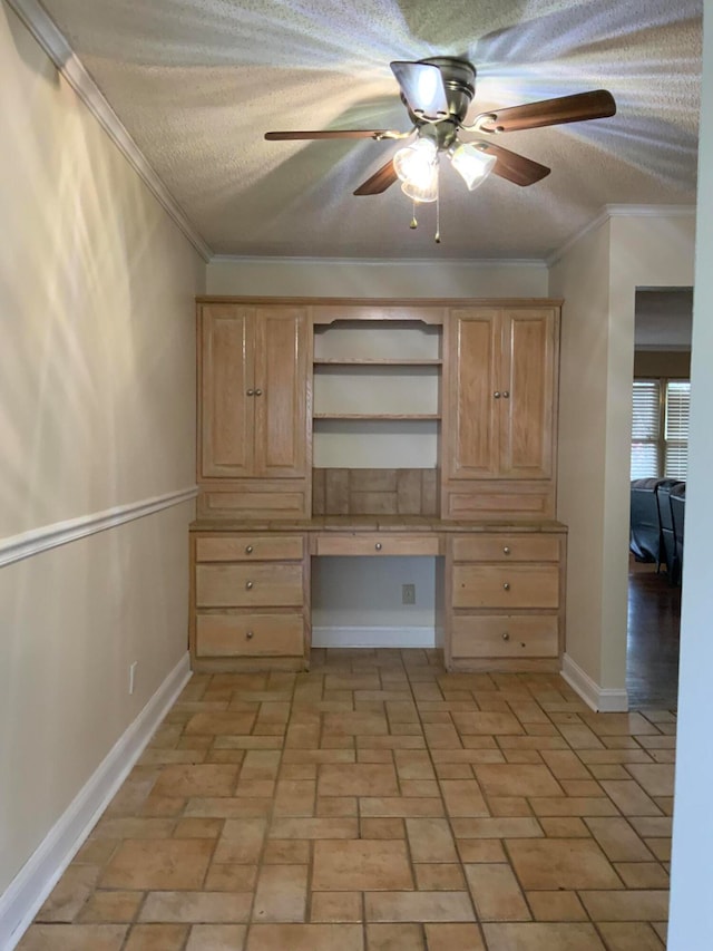 interior space featuring ceiling fan, crown molding, built in desk, and a textured ceiling