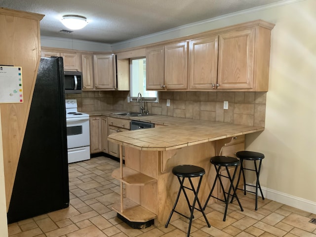 kitchen with backsplash, tile counters, kitchen peninsula, and stainless steel appliances