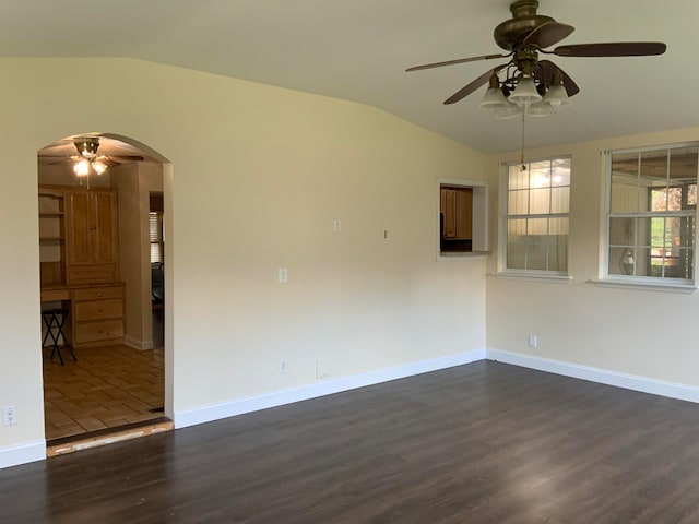 unfurnished room with dark hardwood / wood-style floors, ceiling fan, and lofted ceiling