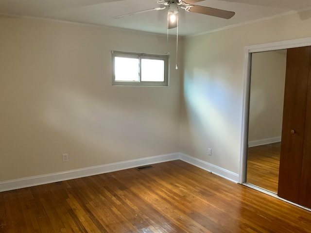 unfurnished room with crown molding, ceiling fan, and wood-type flooring