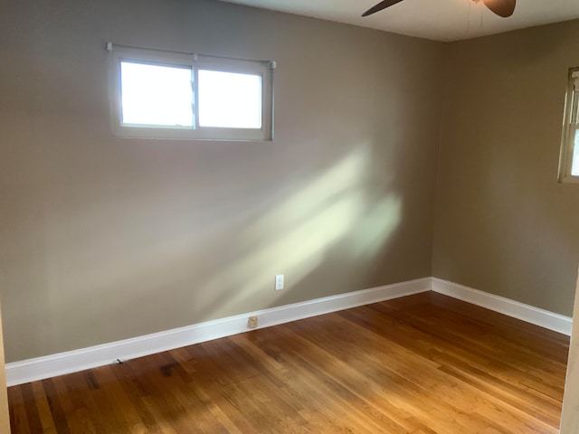 spare room with hardwood / wood-style flooring and ceiling fan