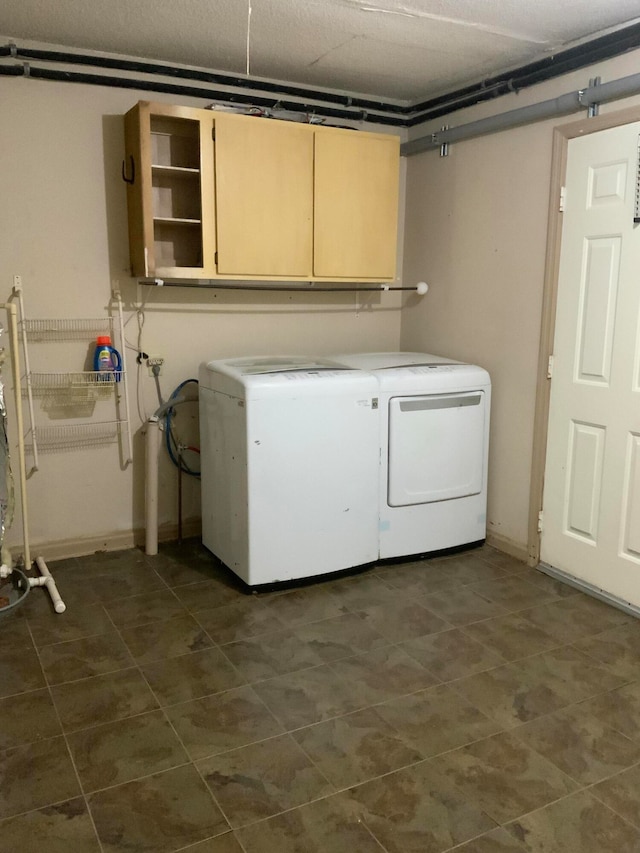 washroom with cabinets and washer and clothes dryer