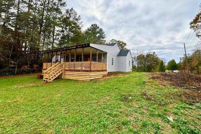 back of house with a yard and a wooden deck