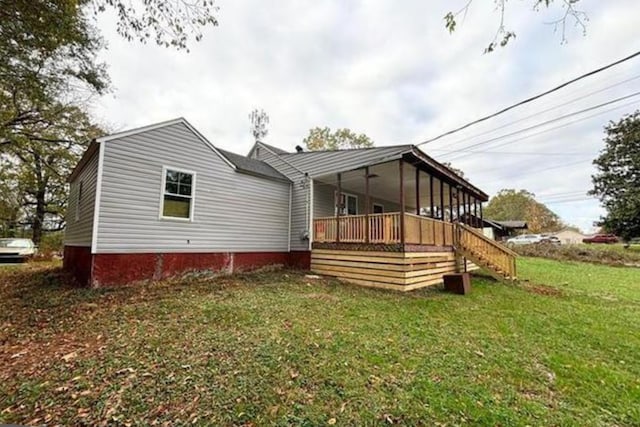 rear view of property with a lawn