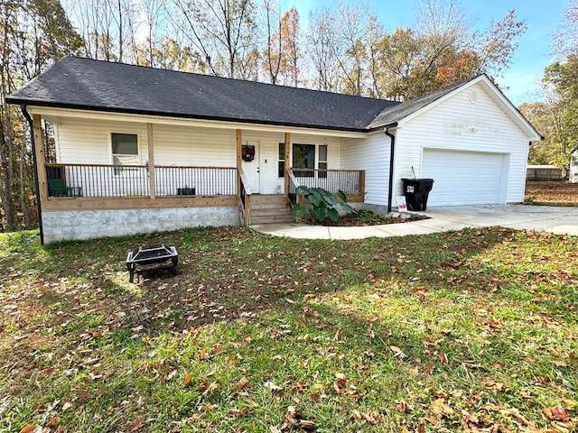 ranch-style home featuring covered porch and a garage