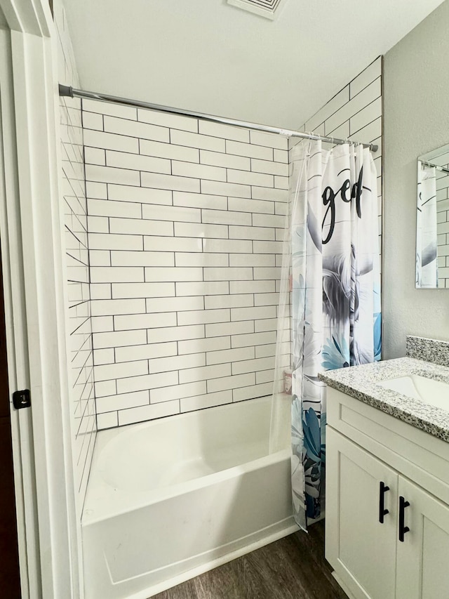 bathroom with vanity, shower / bathtub combination with curtain, and hardwood / wood-style flooring