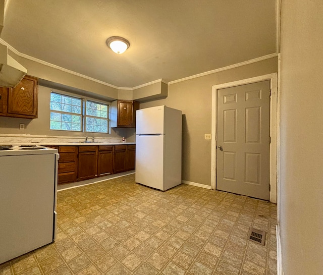 kitchen with range hood, sink, white appliances, and ornamental molding