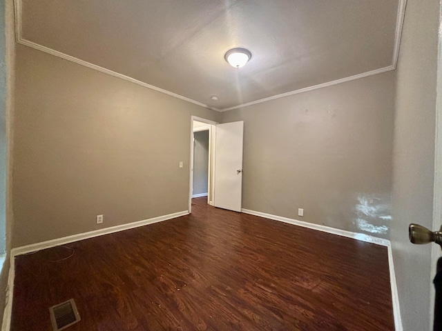 spare room with dark hardwood / wood-style flooring and ornamental molding