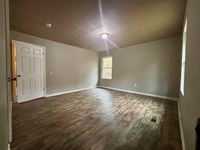 empty room featuring dark wood-type flooring