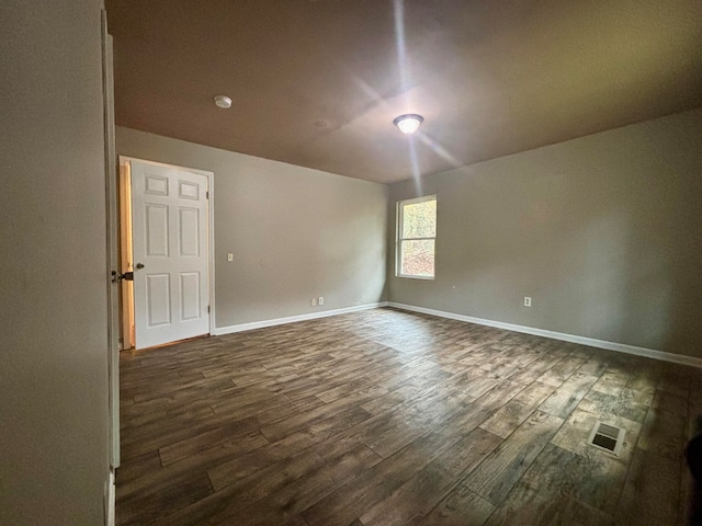 empty room with dark wood-type flooring