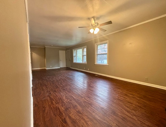 empty room featuring crown molding, ceiling fan, and dark wood-type flooring