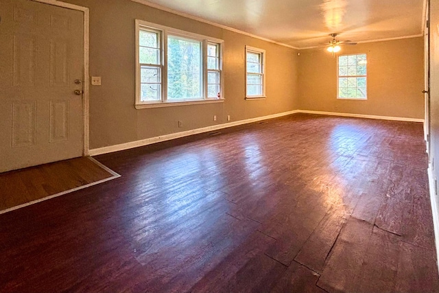 interior space with baseboards, dark wood-type flooring, and crown molding