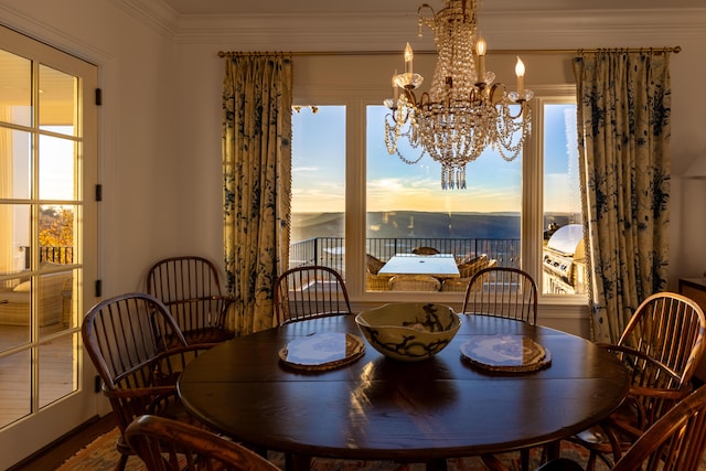 dining space with a wealth of natural light, crown molding, and hardwood / wood-style flooring