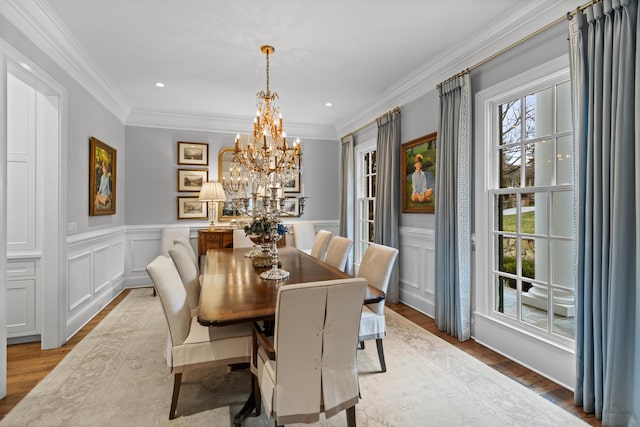 dining room with plenty of natural light, light wood-type flooring, and ornamental molding