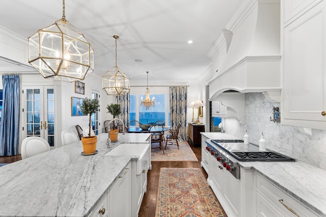 kitchen featuring white cabinets, pendant lighting, dark hardwood / wood-style floors, and stainless steel gas cooktop