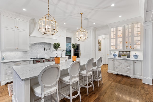 kitchen with white cabinets, dark hardwood / wood-style floors, and hanging light fixtures