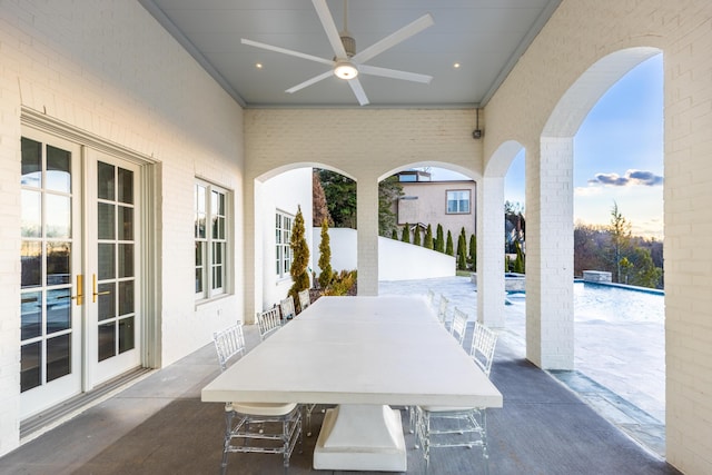 view of patio / terrace with french doors, pool water feature, and ceiling fan