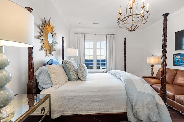 bedroom with dark wood-type flooring, a notable chandelier, and ornamental molding