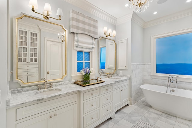 bathroom with a bathtub, crown molding, vanity, and tile walls