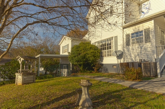 view of property exterior with central AC unit and a lawn