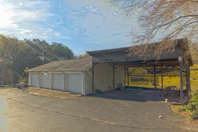 view of home's exterior with a carport and a garage