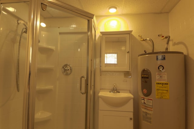 bathroom featuring water heater, a textured ceiling, vanity, a shower with shower door, and tile walls