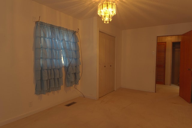 interior space featuring carpet and an inviting chandelier