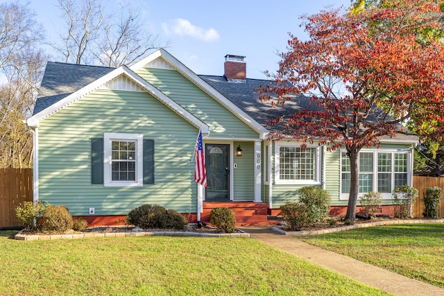 bungalow-style home with a front yard