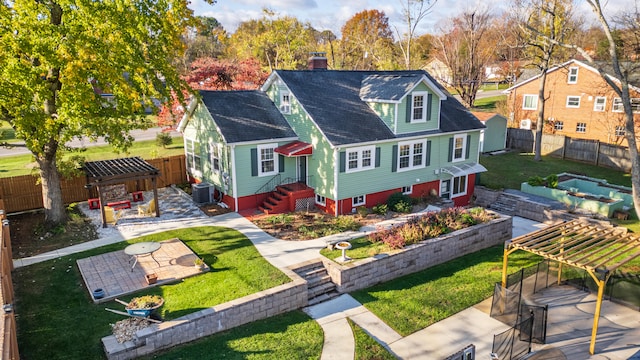 back of property with a pergola, a patio area, and central air condition unit