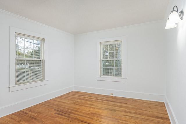 empty room featuring crown molding and wood-type flooring