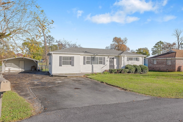 single story home with a front lawn and a carport