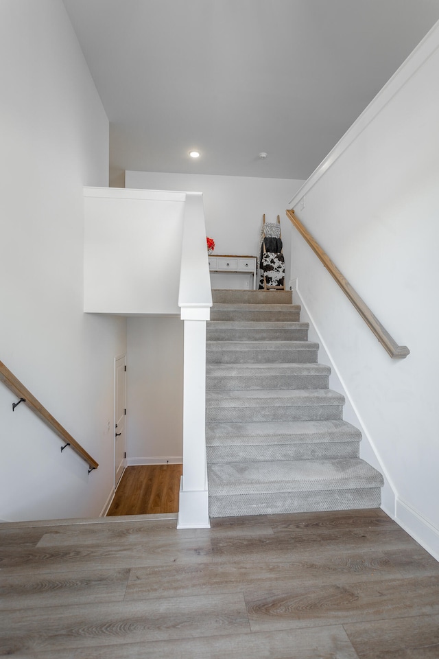 stairs featuring hardwood / wood-style flooring