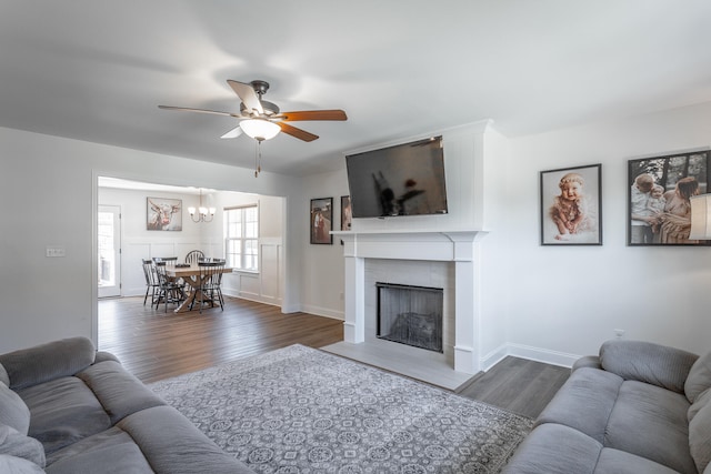 living room featuring dark hardwood / wood-style floors and ceiling fan with notable chandelier