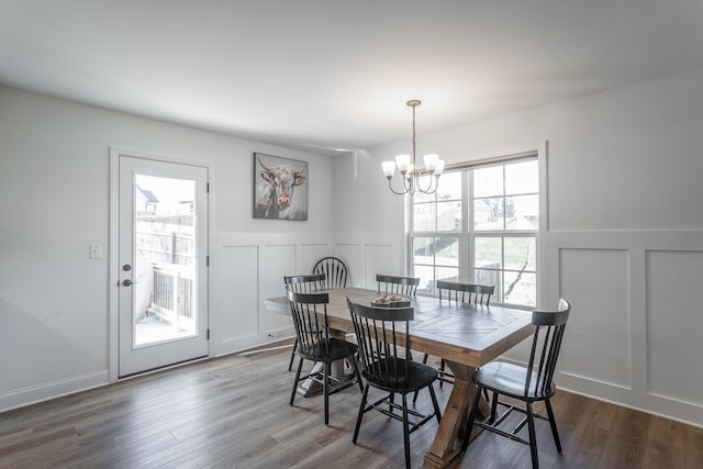 dining space with a notable chandelier and hardwood / wood-style flooring