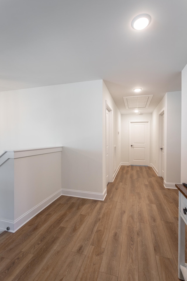 hallway with hardwood / wood-style floors