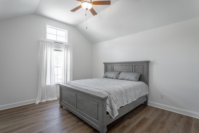 bedroom featuring dark hardwood / wood-style floors, vaulted ceiling, and ceiling fan