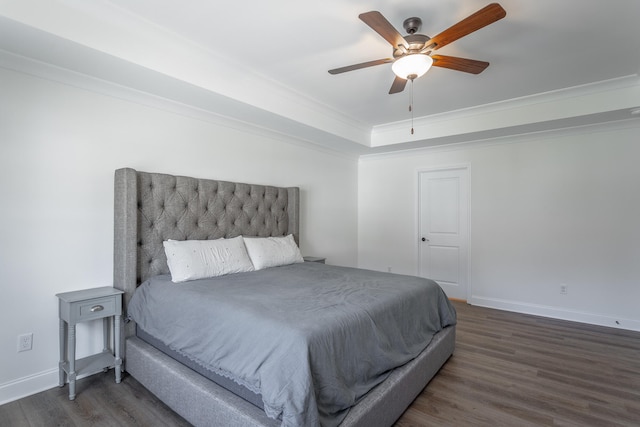 bedroom featuring ceiling fan, dark hardwood / wood-style flooring, and crown molding