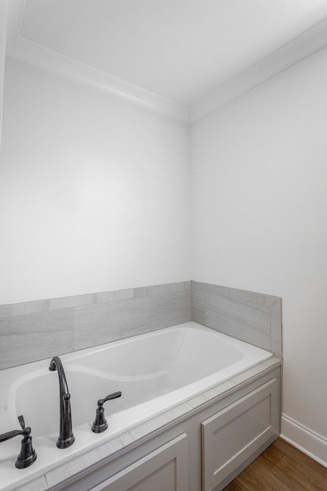 bathroom with ornamental molding and hardwood / wood-style flooring