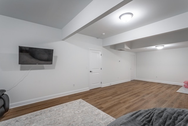 interior space with beamed ceiling and dark hardwood / wood-style floors