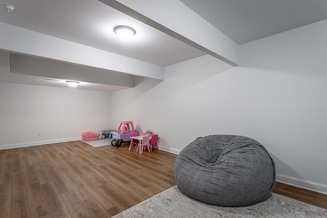 rec room featuring beamed ceiling and dark hardwood / wood-style floors