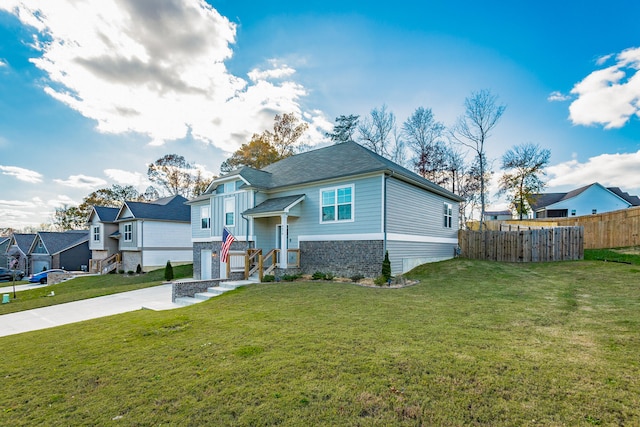 view of front of house with a garage and a front lawn