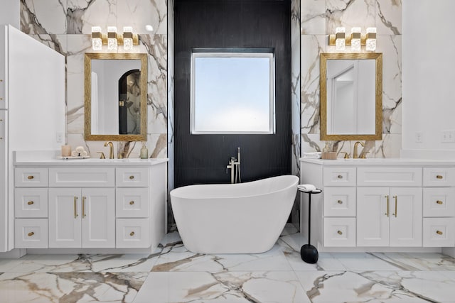 bathroom with vanity, a bath, and tile walls