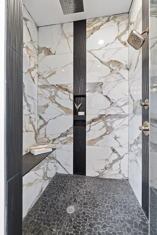 bathroom with walk in shower and tile walls