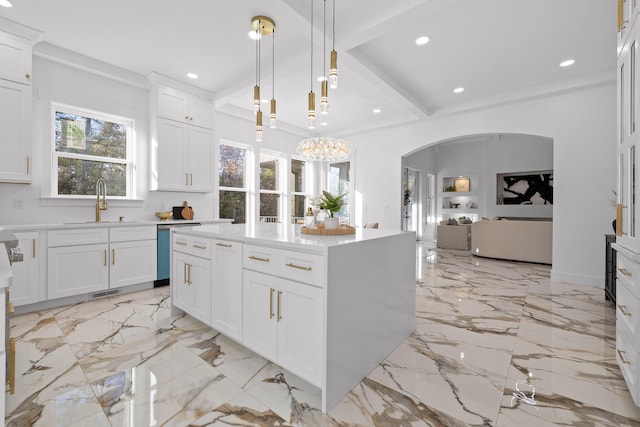 kitchen featuring dishwasher, a center island, white cabinets, hanging light fixtures, and beamed ceiling