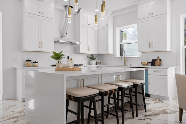 kitchen with white cabinets, a breakfast bar, decorative light fixtures, and a kitchen island